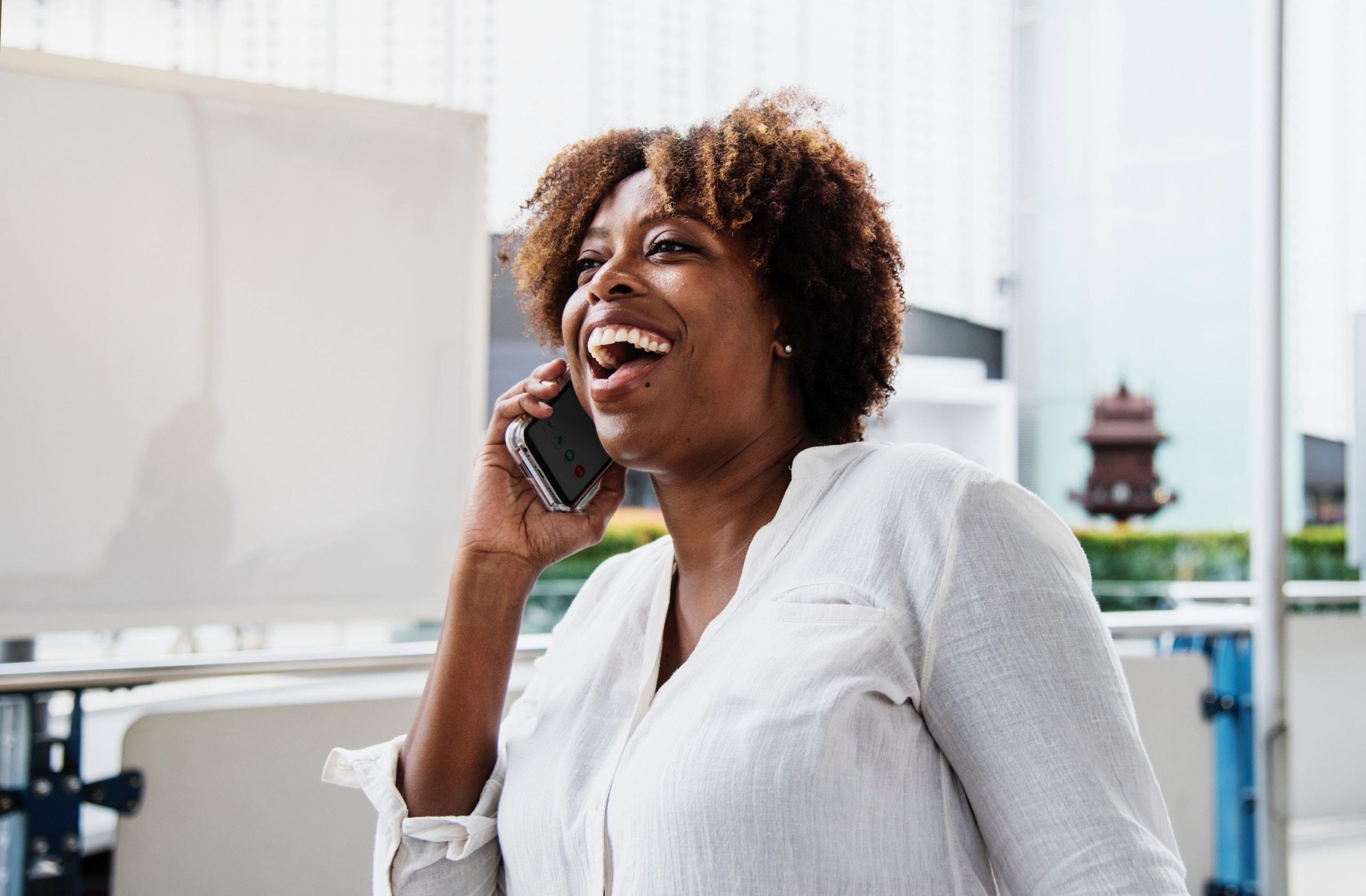 A happy person receiving a phone call.