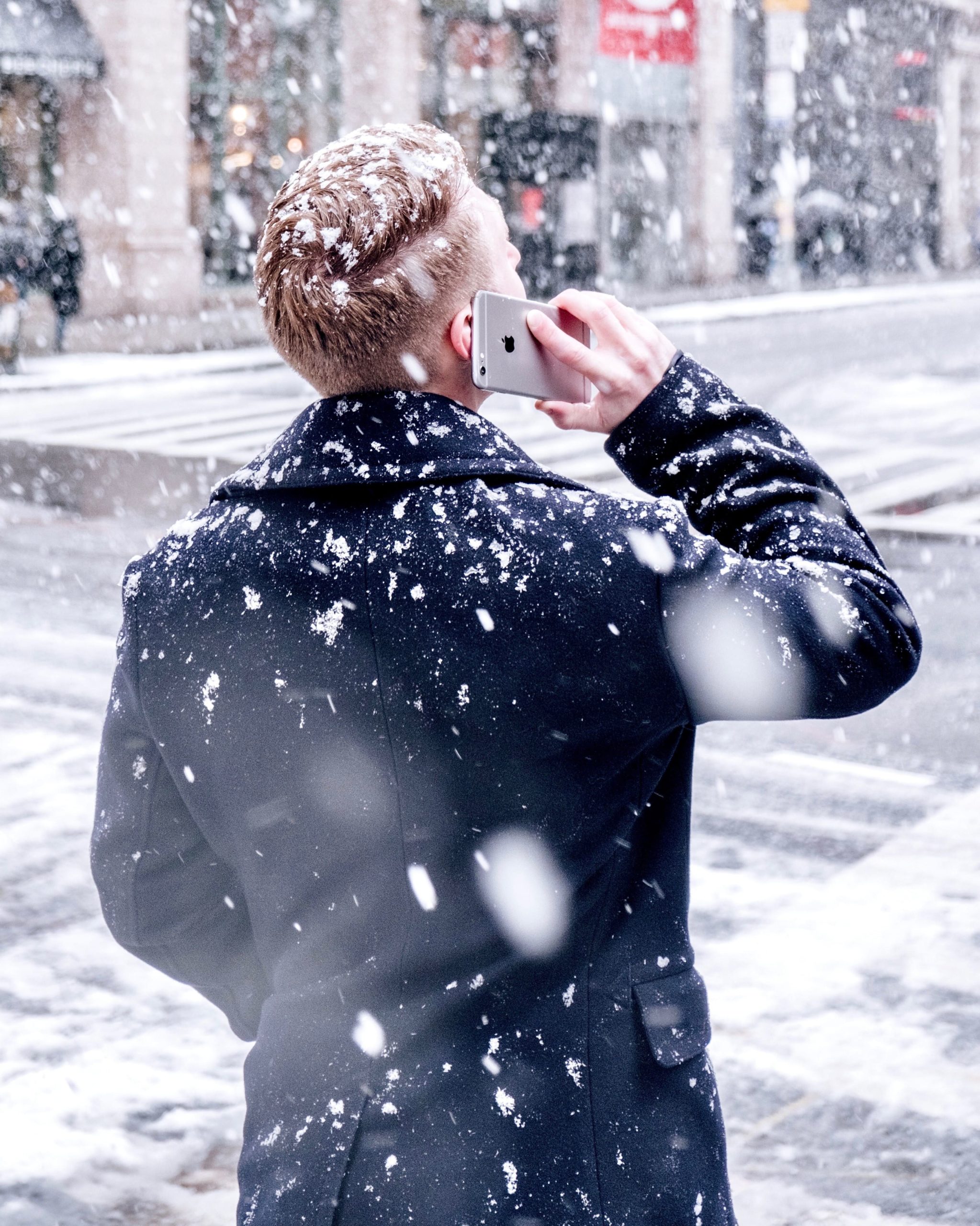 Man making a phone call in the snow.