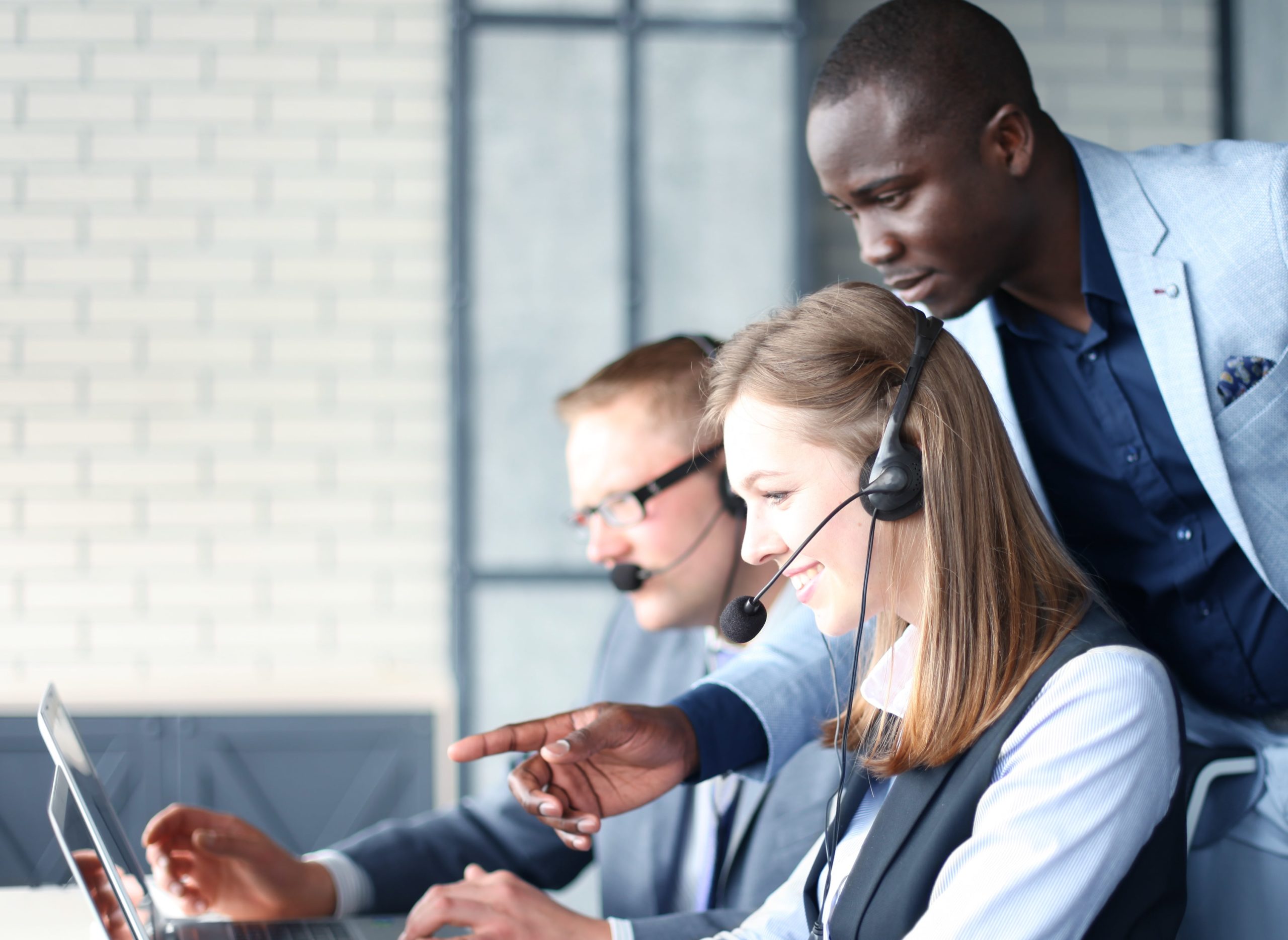 Manager helping call centre employees.