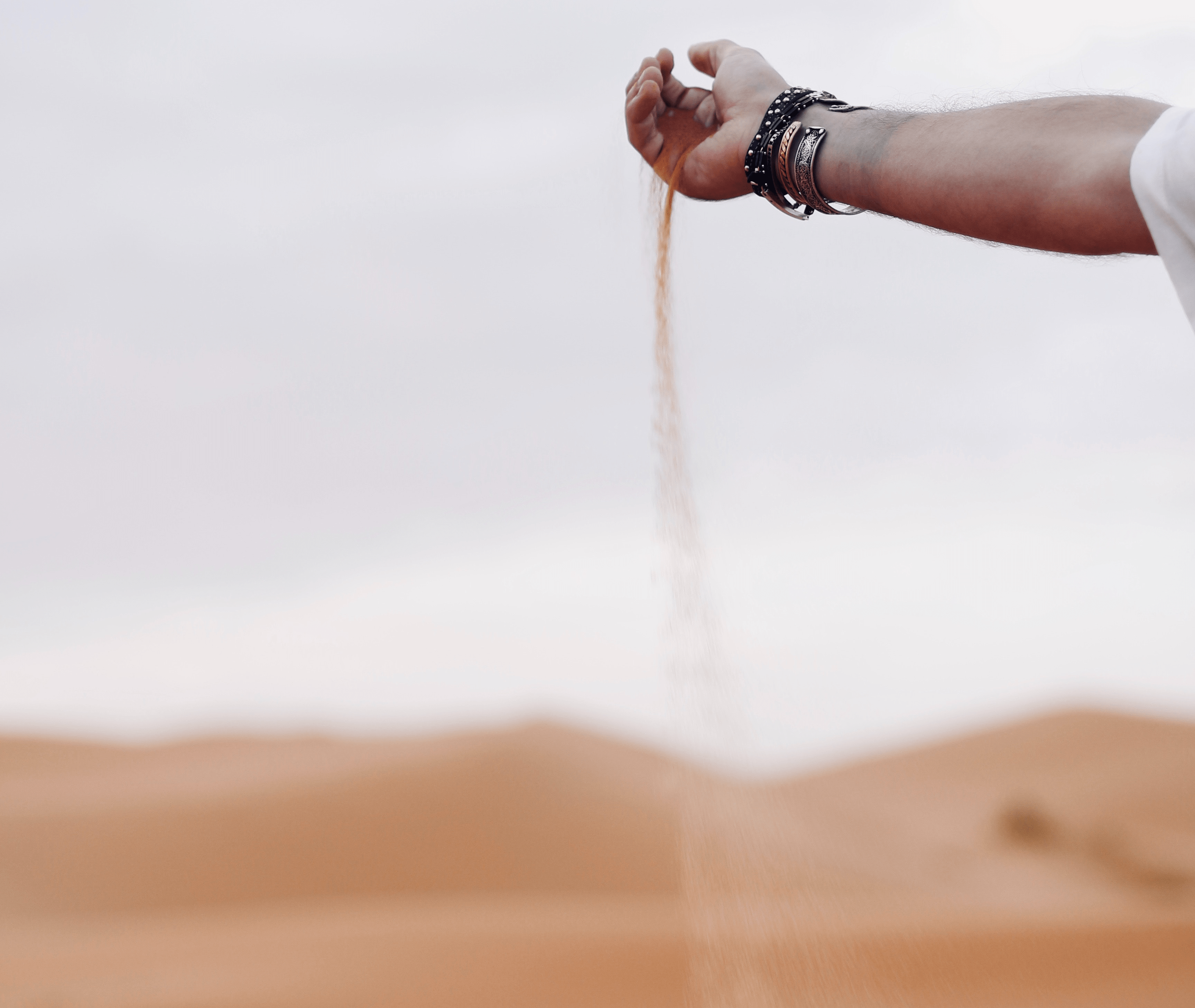 Person holding and dropping sand.