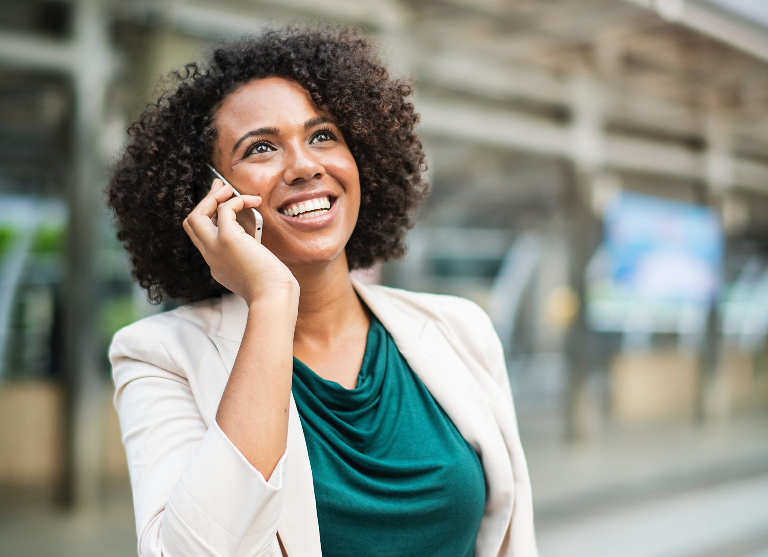 Smiling woman talking on phone.